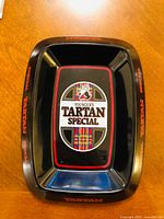 Top view of rectangular black Younger’s Tartan Special ashtray