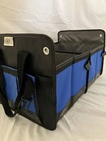 Organizer angled view showing two compartments, handles, side mesh pocket