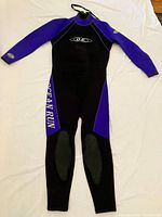 Front view of black and purple Ocean Run Sport full-length wetsuit
