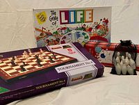 All three boxed games grouped: Life, Chess, Bowling with pins pouch