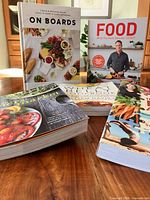 All five cookbooks displayed on table, covers visible