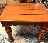Top view of solid wood side table showing plank top and finish