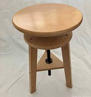 Assembled view of beechwood drafting stool showing circular seat and height adjust screw