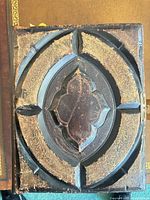 Front cover showing embossed leather design, gilt tooling, metal clasp