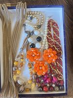 All six necklaces arranged in box overview