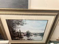 Framed landscape print showing full artwork, mat and gold ornate frame