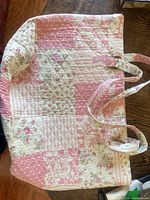 Exterior of large pink and ivory quilted patchwork tote with twin straps