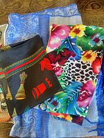 Group of four scarves showing colours and patterns