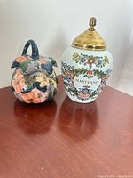 Front view of both jars showing decorative exteriors and brass lid installed on Maryland jar