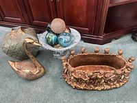 Group view of planter, swan, vase, urn with orbs