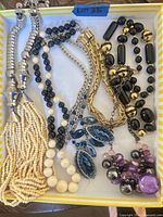 All seven necklaces laid flat inside box for overview