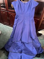 Full view of the royal blue gown front showing tiered skirt and bodice