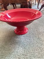 side view showing pedestal base and red glossy finish