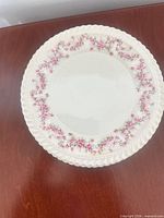 Front view of saucer showing floral garland and rope rim