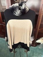 Front view of color-block poncho with faux fur cowl neck