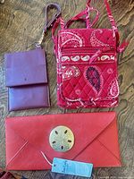 Front view of three bags showing colors, styles, hardware and hangtag