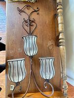 Full view of metal 3-light wall sconce with glass shades