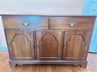 Front view showing drawers, cabinet doors, hardware, base