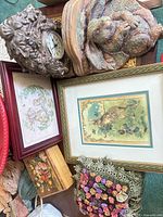 Group shot showing rabbit mantle clock, mottled rabbit figurine, framed prints, floral box, rosette cushion