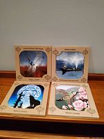 Front view showing all four Andy Everson ceramic tile designs in sleeves