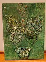 Full front view of green mixed media butterfly artwork on panel