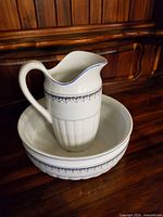 Pitcher placed inside matching basin showing overall design and trim