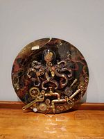 Full frontal view of round steampunk octopus wall art