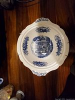 Large scalloped blue transferware serving bowl with building scene and floral border