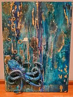 Full front view of resin-coated panel showing octopus and textured background