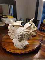 Group view showing chief bust and multiple dragon bisques