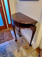 Demilune table with lower shelf and cabriole legs