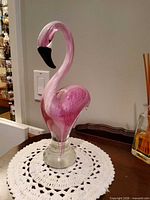 Full view of pink flamingo sculpture front left side