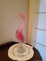 right side view of pink Murano glass duck on doily