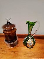 Front view of amber Empoli jar and green Venetian pitcher side by side
