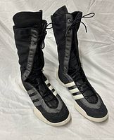 Full view of both boots showing mesh upper, leather tongue, white stripes and rubber sole