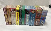 Row of 15 factory-sealed Western VHS tapes showing spines and shrink-wrap