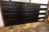Full view of black Clopay sectional garage door