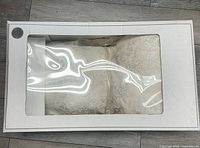 Wedding dress visible through windowed preservation box