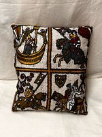Full view of tapestry pillow front showing four medieval panels