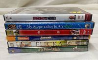 Stacked view of all six sealed DVDs