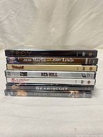 Stack of seven sealed DVD cases showing spines