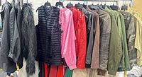 Rack showing multiple jackets of various materials and colours