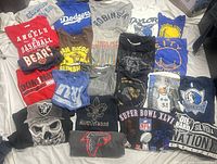 Full layout of 20 visible team T-shirts on surface