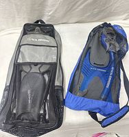 Two mesh bags containing snorkel sets