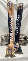 Two scarves displayed plus stacked sealed units