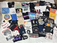 All 50 medium T-shirts laid out showing variety of graphics