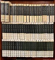 Full bookshelf showing World Book encyclopedia volumes, dictionaries and first rows of year books