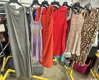 All seven dresses hanging on rack front view