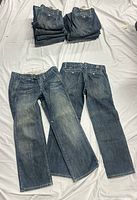 Stacked and laid-out view of all nine Ruehl jeans
