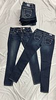 Stack of jeans plus two laid out showing front and full length